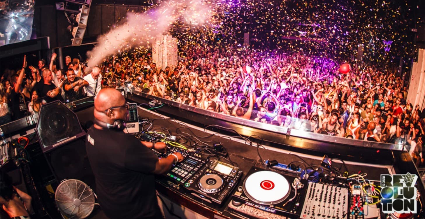 A DJ playing to a packed club